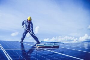 Man carrying out maintenance on solar panels