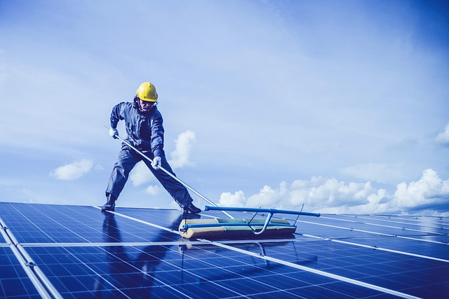 Man carrying out maintenance on solar panels